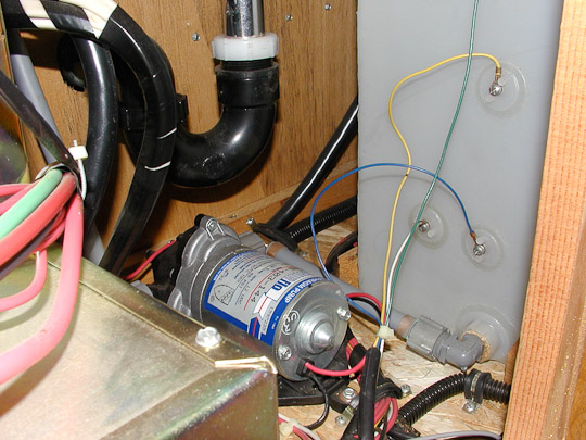 View of water pump under kitchen sink