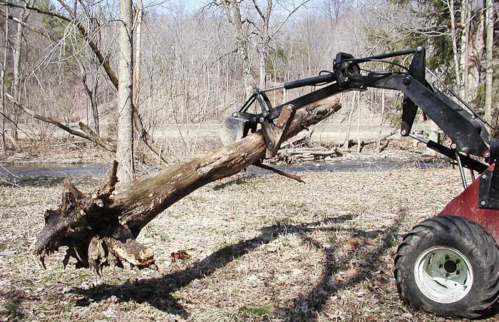 Power-Trac MiniHoe Carrying a Dead Tree to the Burn Pile